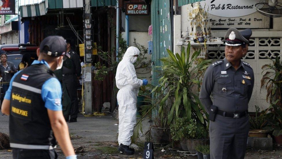 Thai forensic police officers inspect the blast scene in Hua Hin