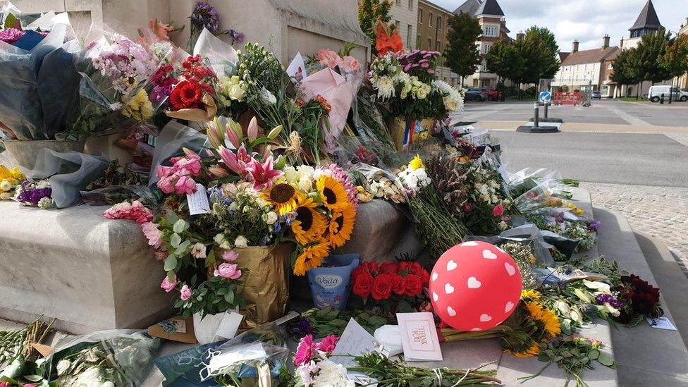 Flowers placed at the base of the Queen Mother statue in Poundbury