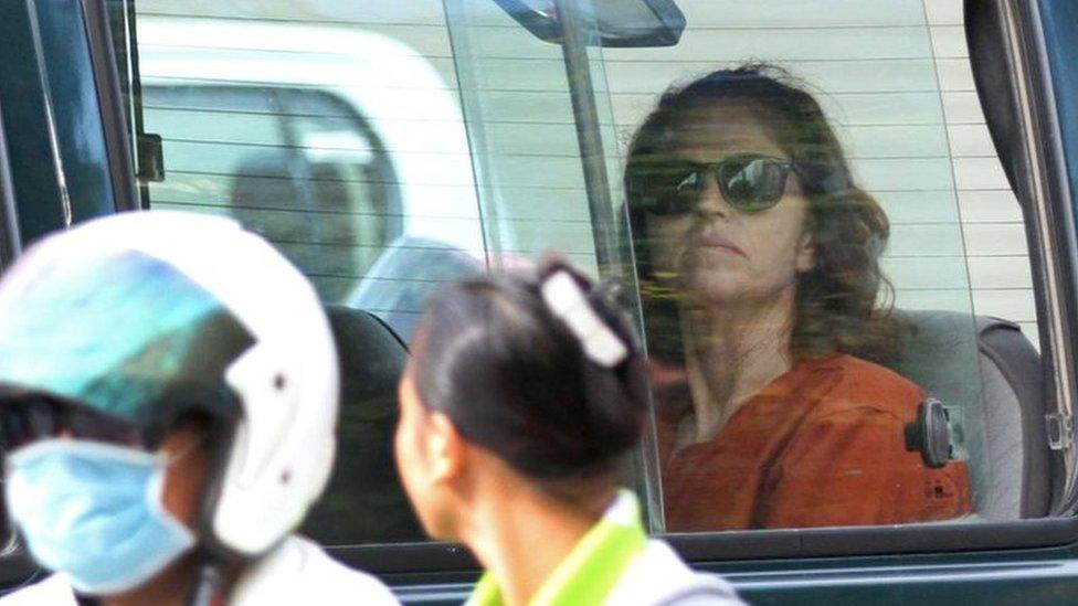 Australian national Tammy Davis-Charles (R), 49, sits in a prison car as she travels to Phnom Penh municipal court on 13 June 2017