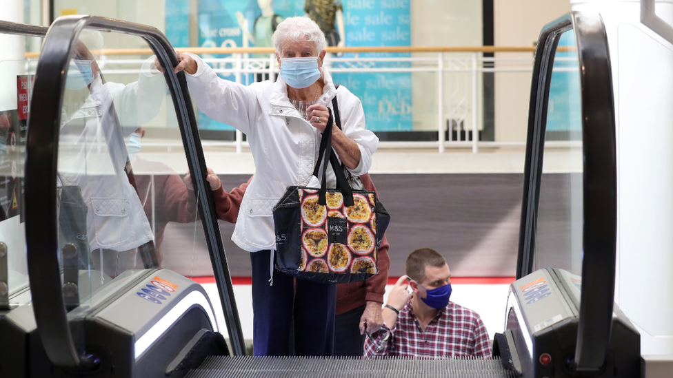 Shopper on escalator