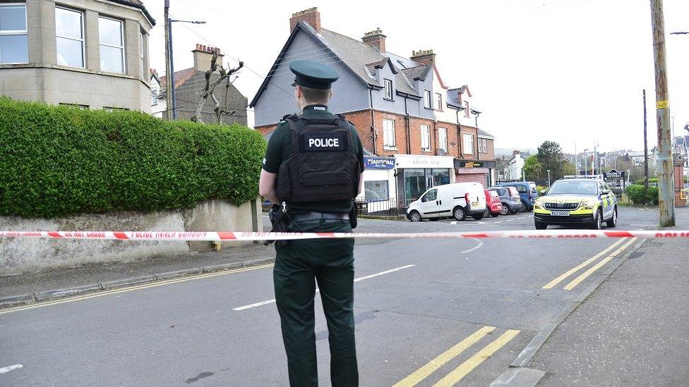 Outside the house after the murder with police officer and cordon around the street