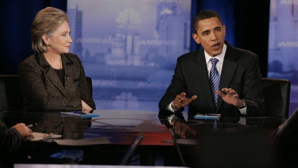 Hillary Clinton looks on as Barack Obama speaks during a debate at Cleveland State University"s Wolstein Center February 2008