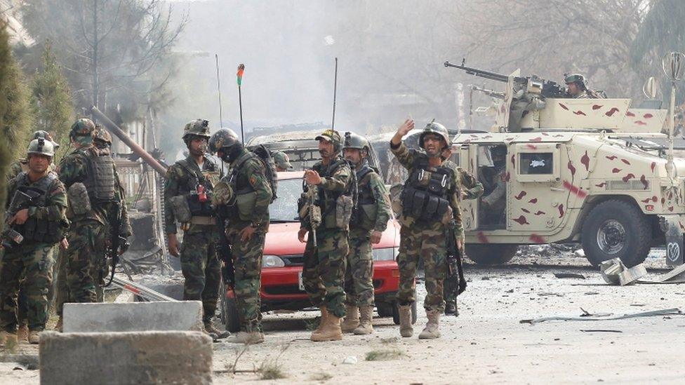 Afghan security officers at the scene of the attack in Jalalabad