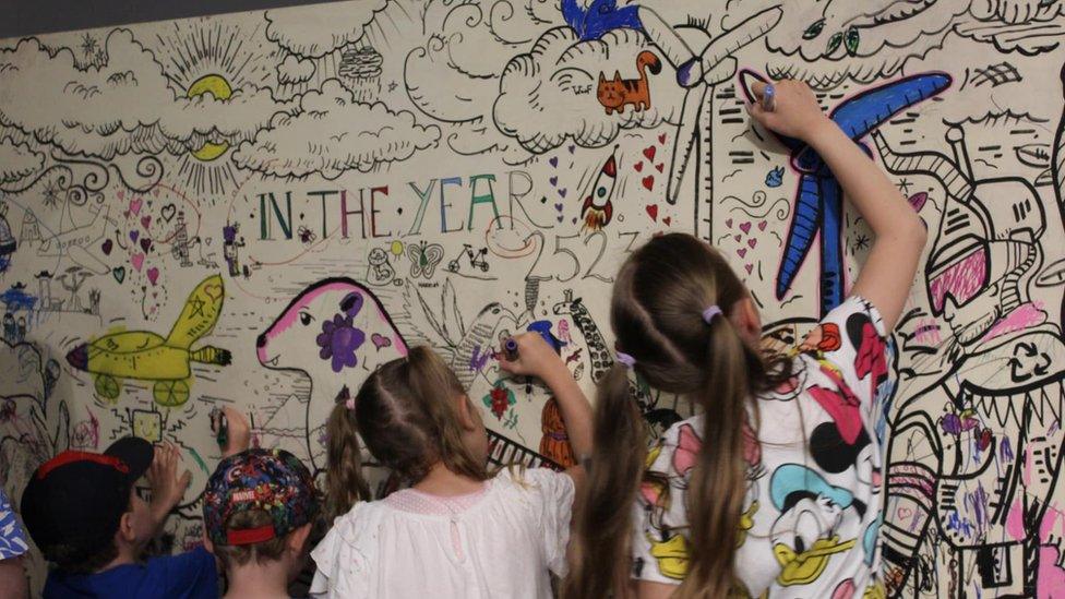 Children drawing on a wall