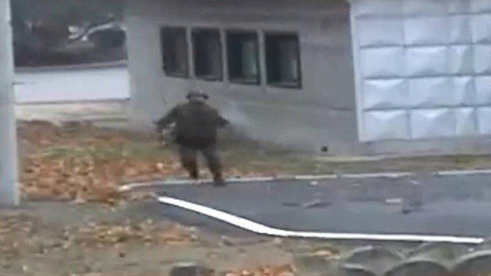 Screengrab of video clips showing North Korean soldier defecting to the South at the JSA