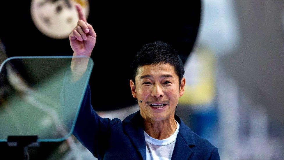 Japanese billionaire Yusaku Maezawa speaks near a Falcon 9 rocket during the announcement by Elon Musk to be the first private passenger who will fly around the Moon, 17 September 2018