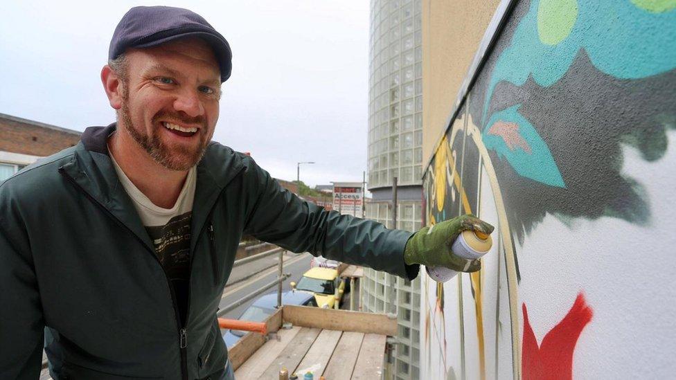 An artist with Bristol art collective Graft