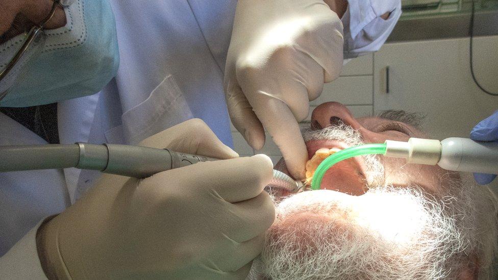 Dentist working on patient's teeth