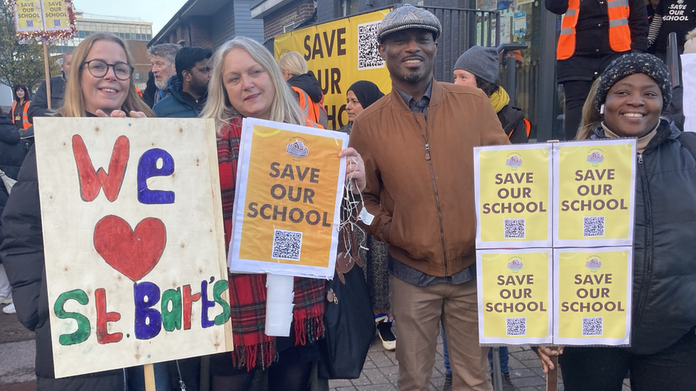 Adults holding signs at the march