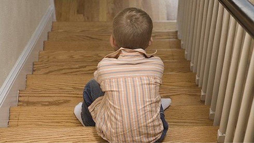 A boy sitting on a staircase