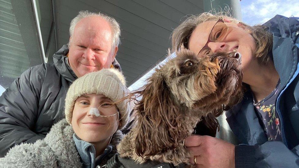 Molly Leonard with her parents and their dog in February