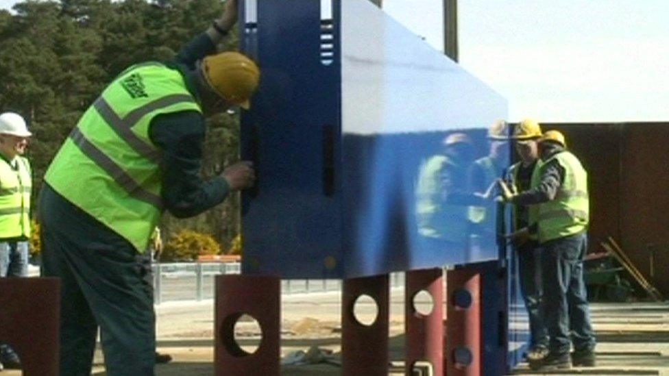 Builder putting together a protective wall