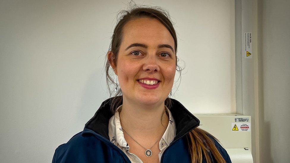 Anne-Marie Ratcliffe head shot in front of battery cables