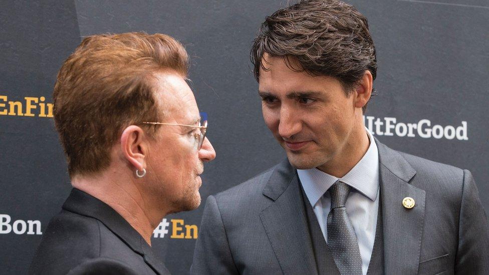 Canadian Prime Minister Justin Trudeau greets U2 singer Bono as he arrives for the Fifth Replenishment Conference of the Global Fund to Fight AIDS, Tuberculosis and Malaria in Montreal, Quebec, on September 17, 2016.