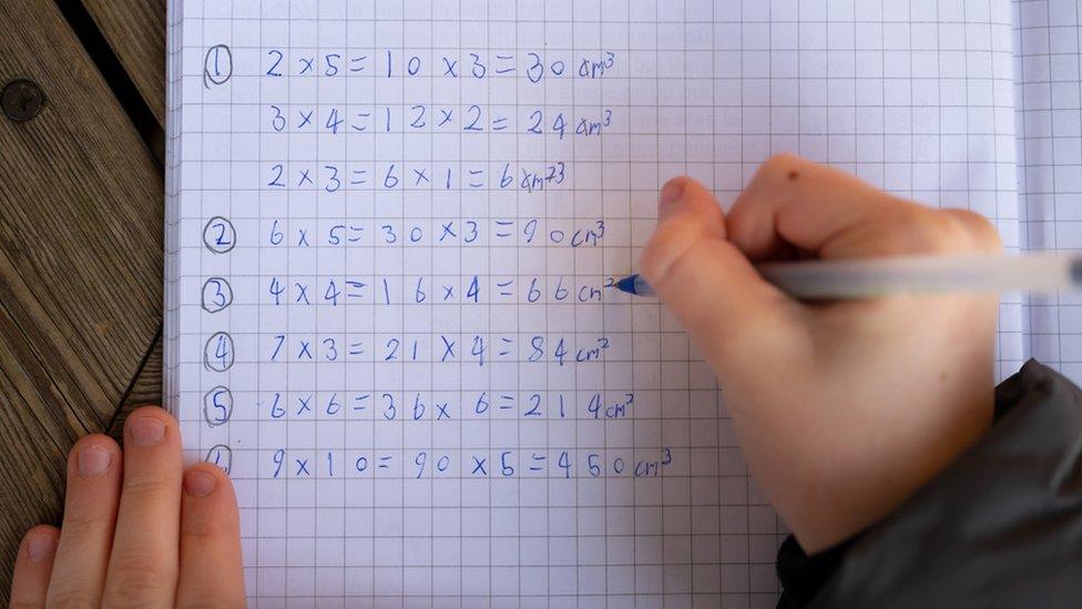 View over the shoulder of a pupil doing maths