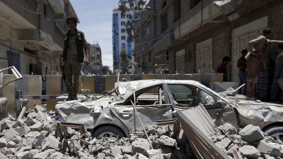 Man walks through bomb rumble in a Sana'a Yemen