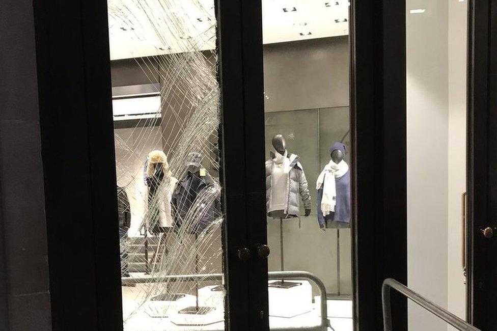 Smashed shop window at Canada Goose