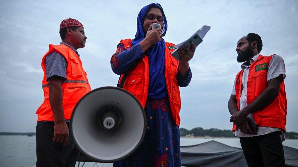 Three volunteers with loudspeaker