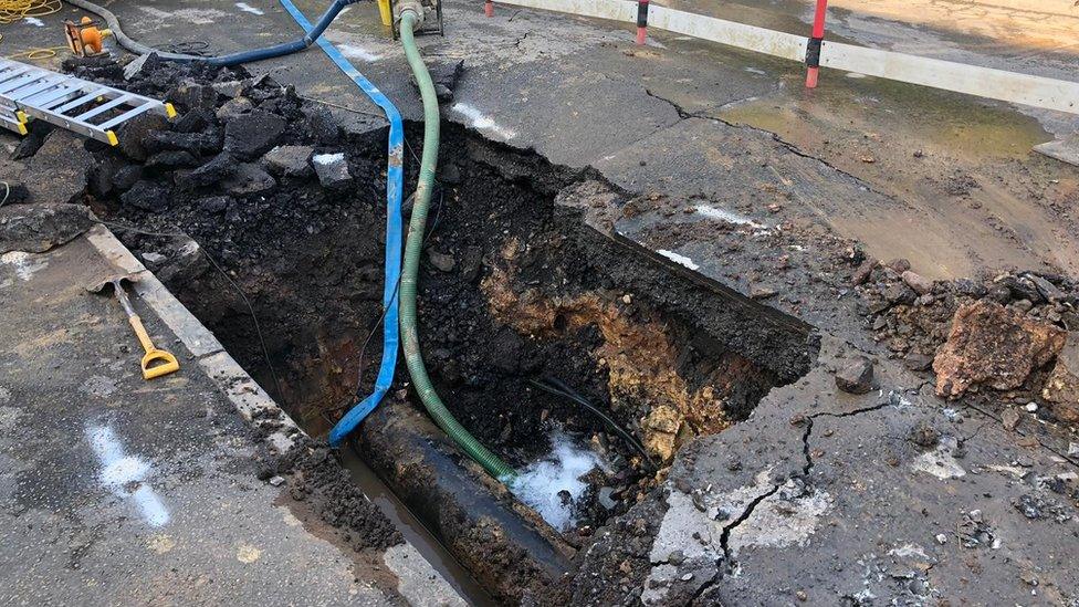 Hole in road at burst main site