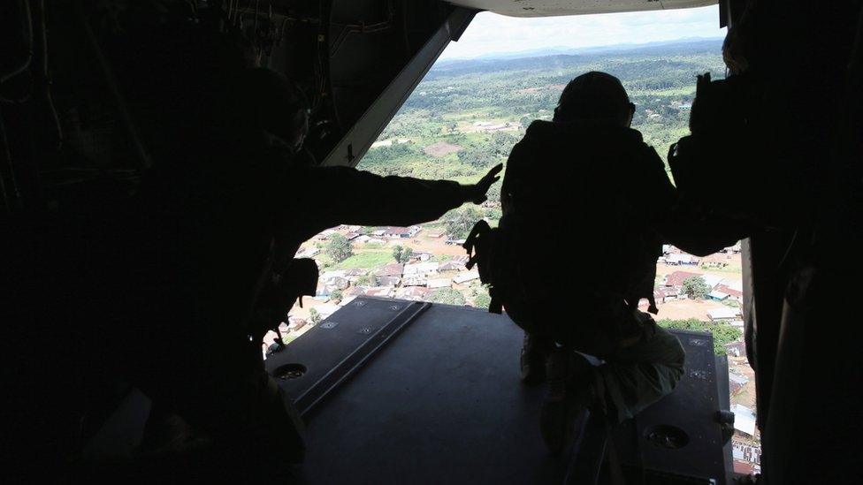 Silhouette of US Marine looking out of an MV-22 Osprey tiltrotor