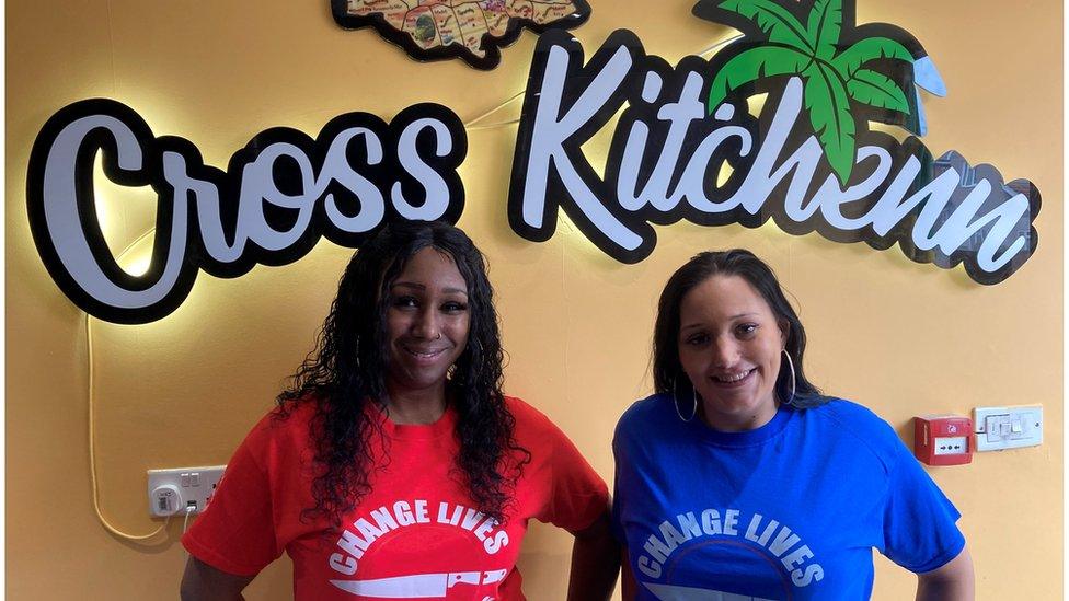 Miss Turner, right, with her friend, Danyelle King standing together in Caribbean restaurant, Cross Kitchenn, which is used as a safe place for people to hand in knives and weapons