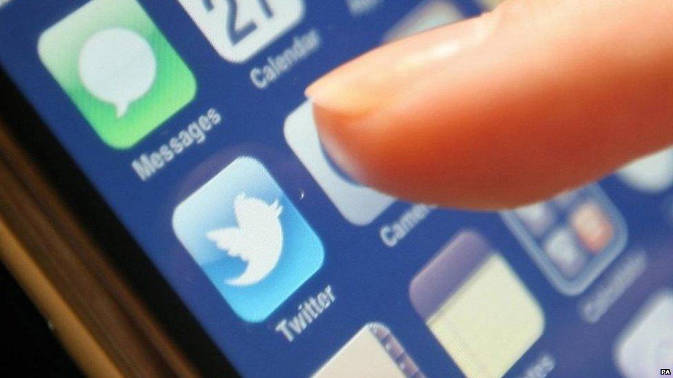 Close up on a finger about to press the Twitter icon on a mobile phoneSocial media