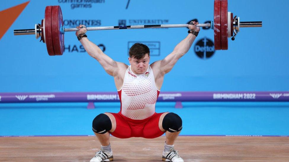 Chris Murray of Team England performs a snatch during Men's 81kg Final on day four of the Birmingham 2022 Commonwealth Games.