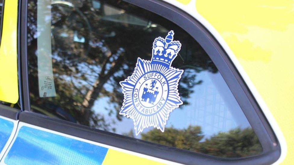 Suffolk Police logo on a police car.