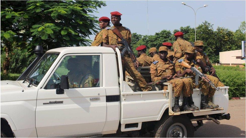 Burkina Faso"s loyalist soldiers stand guard at the airport in Ouagadougo