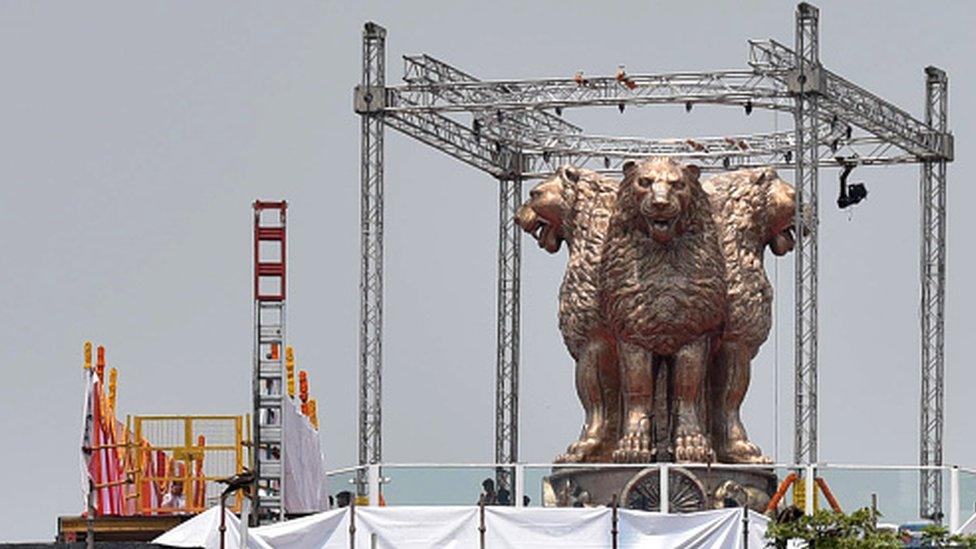 A view of the national emblem on the roof of the New Parliament House building in New Delhi, India.