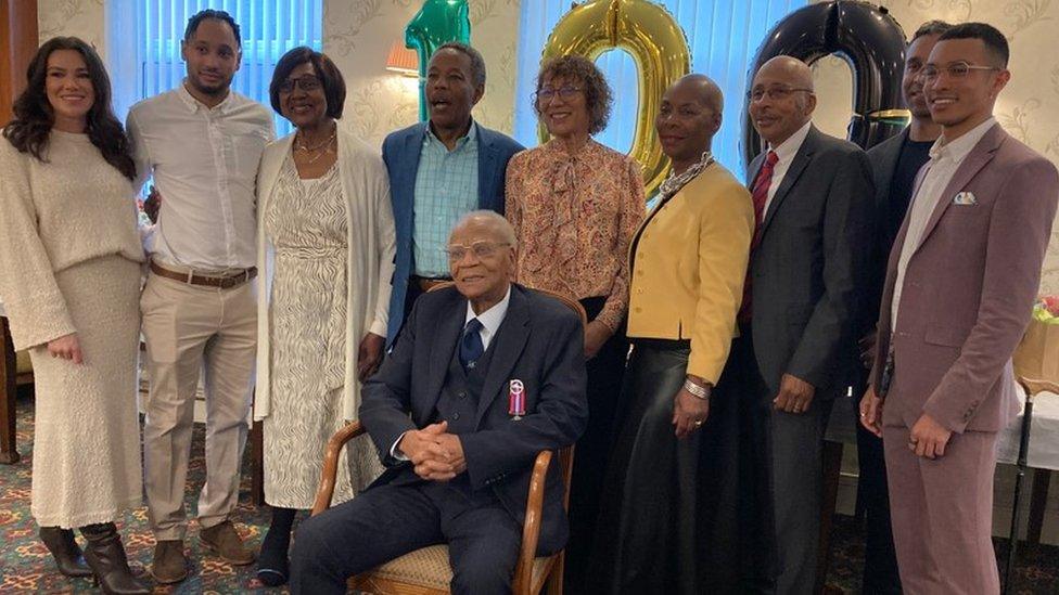 Mr Ottey pictured with friends and members of his family