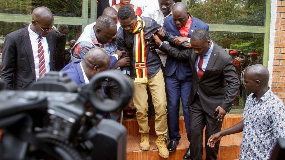 Uganda's prominent opposition politician Robert Kyagulanyi known as Bobi Wine (C) walks ahead of appearing at the general court martial in Gulu, northern Uganda on August 23, 2018