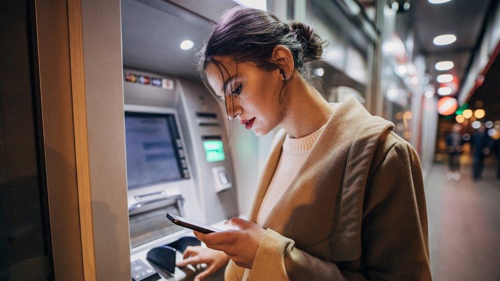 Woman at cash machine