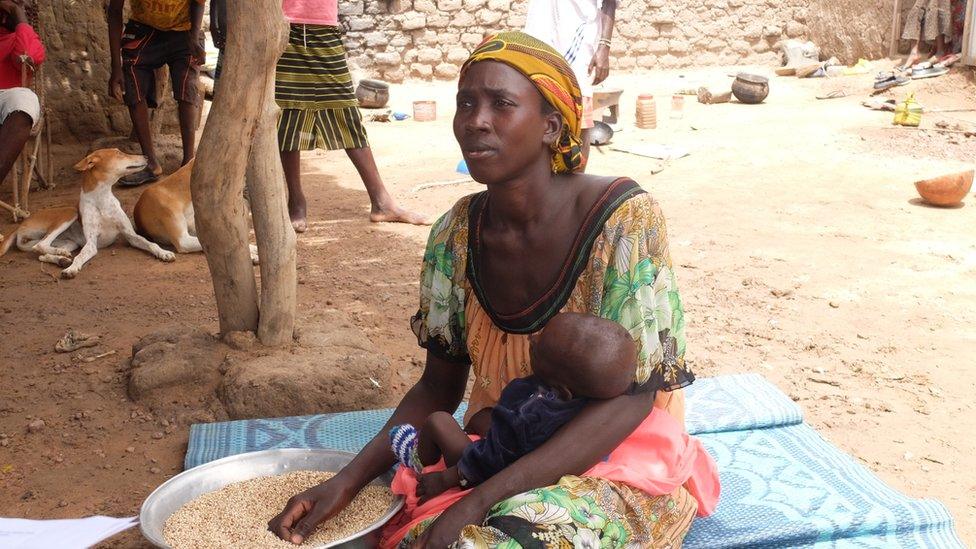 Sanihan Thera with her child in the village of Baramadougou, central Mali