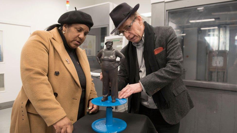 Joy Battick and Kevin Atherton look at the Joy II statue in a studio