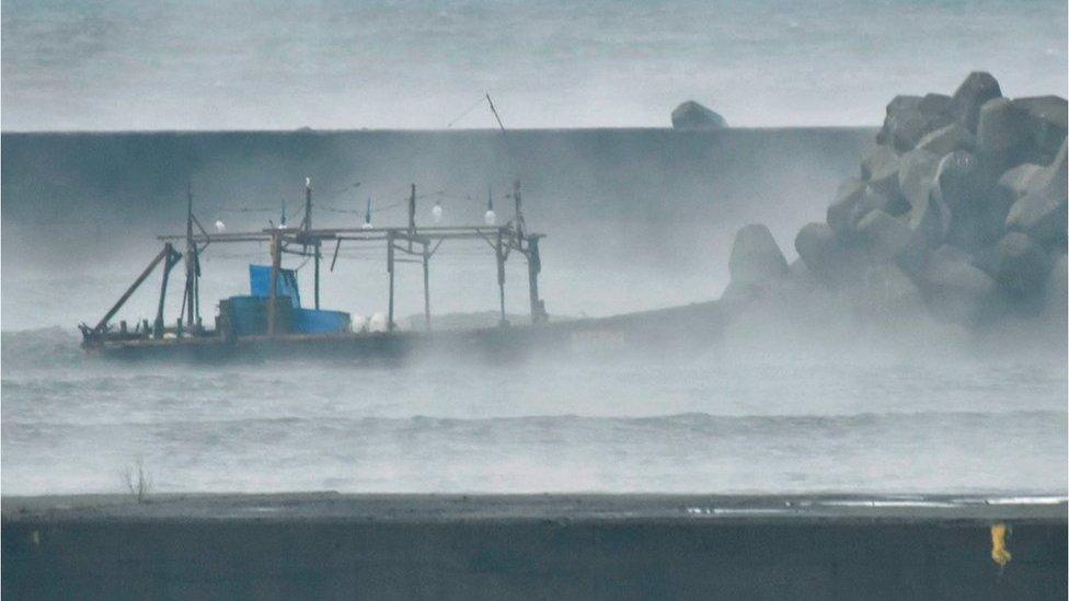 A wooden boat is seen in front of a breakwater in Yurihonjo, Akita Prefecture, Japan November 24, 2017.