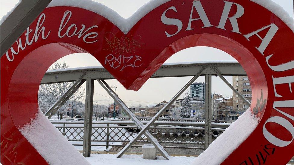 A welcome sign greets visitors on a bridge in Sarajevo