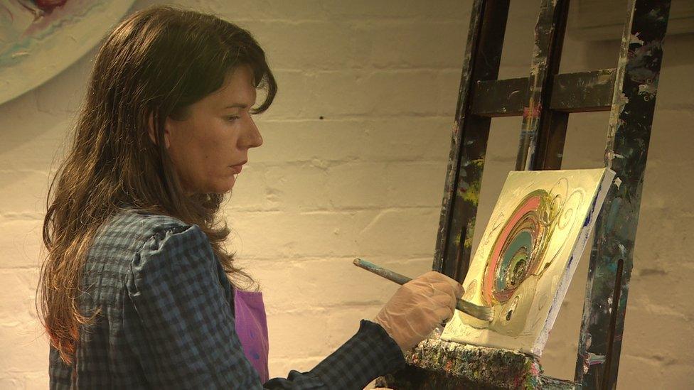 Dawn Crothers painting in her studio