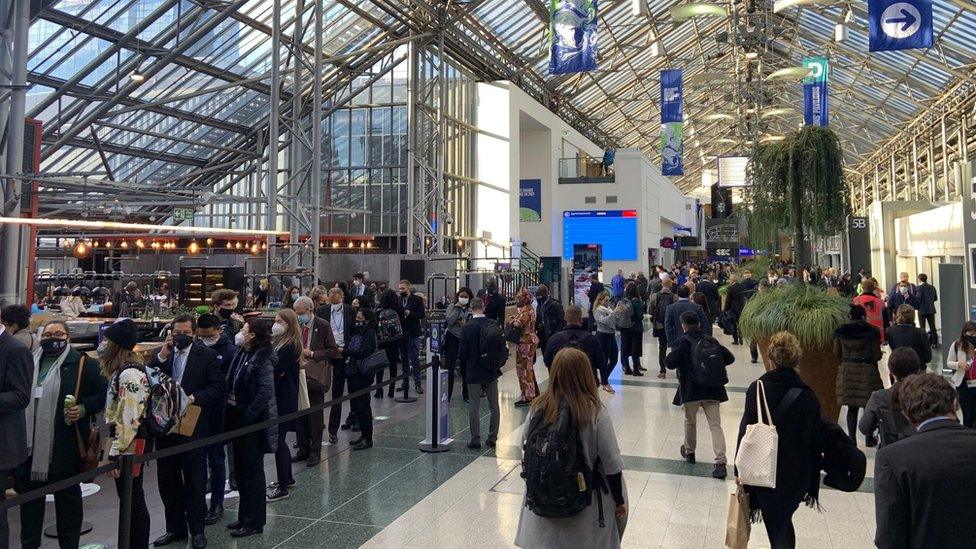 Inside the blue zone, there are people from all over the world, checking their phones