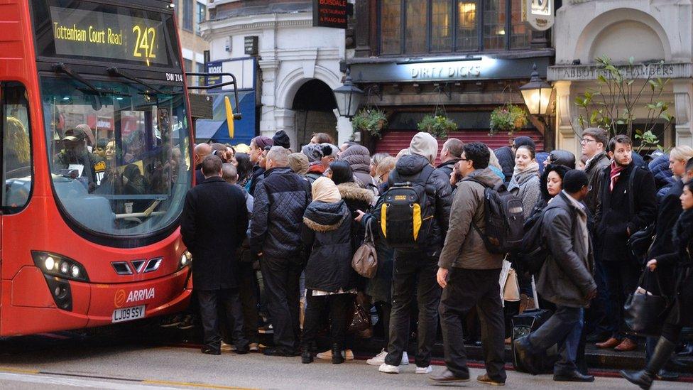 Commuters queuing for buses at Liverpool Street station