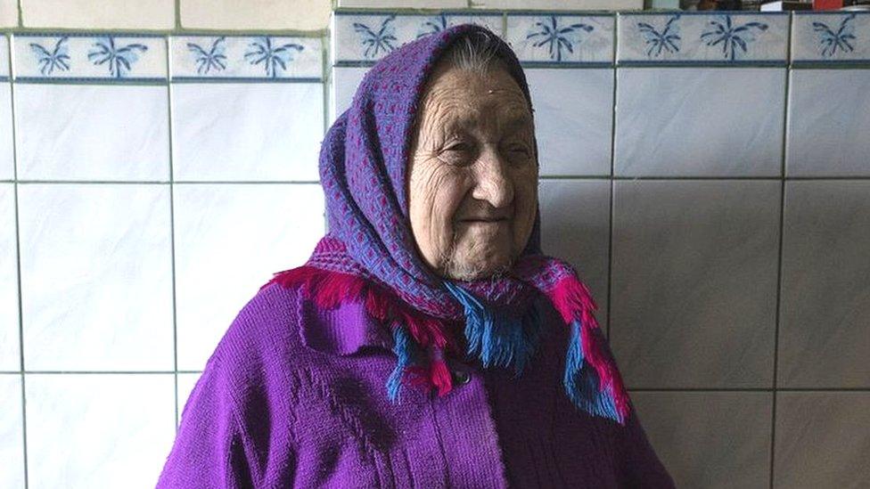 Image shows old woman wearing shawl