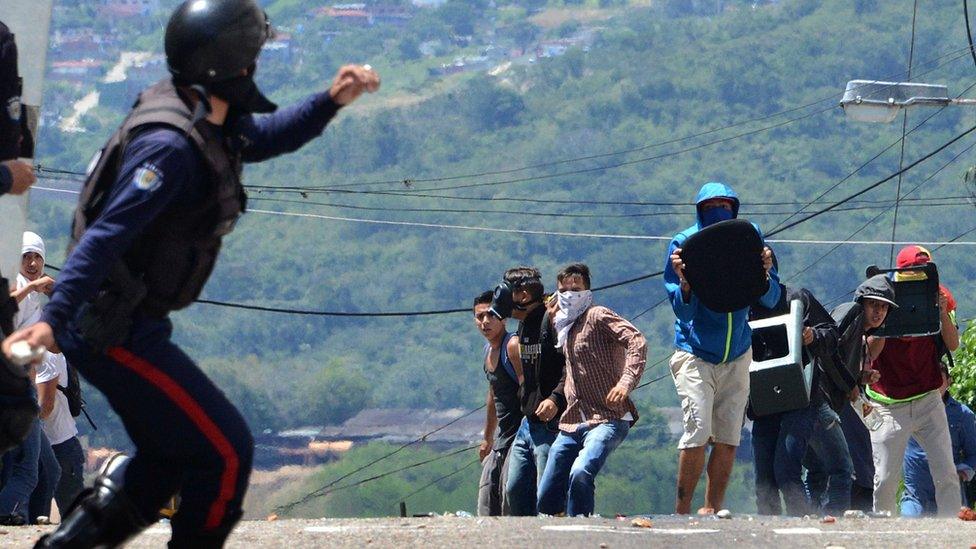 A member of the riot police throws a tear gas bomb during a protest by students opponent to Nicolas Maduro's government in San Cristobal, state of Tachira, Venezuela on October 24, 2016