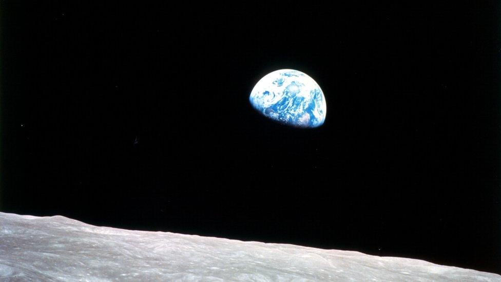 This view of the rising Earth greeted the Apollo 8 astronauts as they came from behind the Moon after the lunar orbit insertion burn.