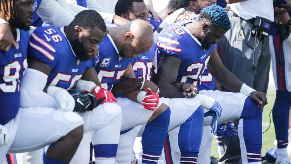 Buffalo Bills players kneel during the American National anthem before an NFL game against the Denver Broncos, 24 September 2017