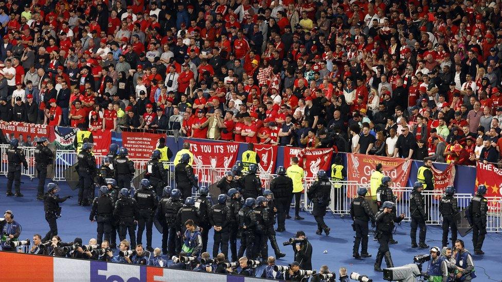 General view of Liverpool fans in the stands as police officers and stewards are seen