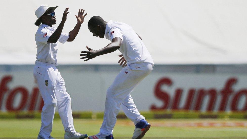 South African bowler Kagiso Rabada (R) congratulates South Africa's fielder Temba Bavuma during the second Test match against England on January 2, 2016