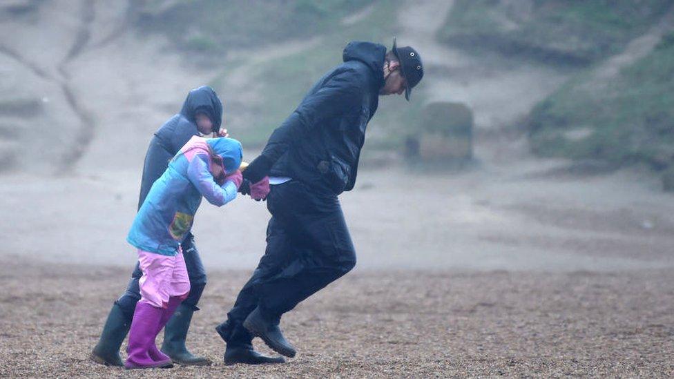 Storm-Ciara-a-family-walk-against-the-wind-during-the-storm.