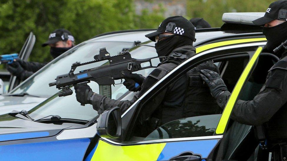 Police firearms officers hold their weapons as they demonstrate a 'compliant stop' during a demonstration for media ahead of the upcoming in-person G7 Summit to be held in Cornwall, at the Police headquarters in Exeter, southwest England on 25 May 2021