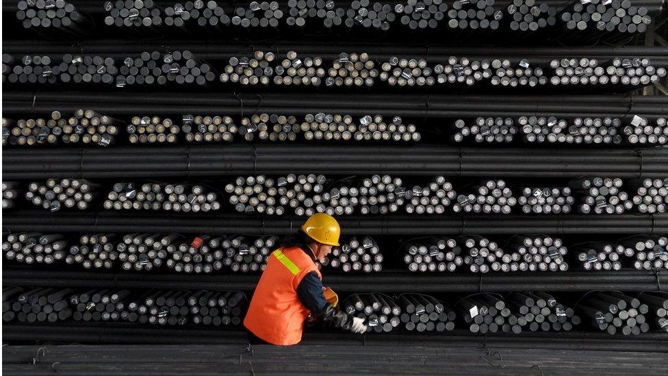 A labourer marks steel bars at a steel and iron factory in Huai"an, Jiangsu province, in this 18 February 2008 file photo.