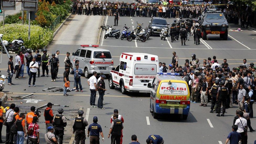 Indonesian police ambulances pass the crowds carrying victims to the hospital after a bomb blast in front of a shopping mall in Jakarta, Indonesia, 14 January 2016